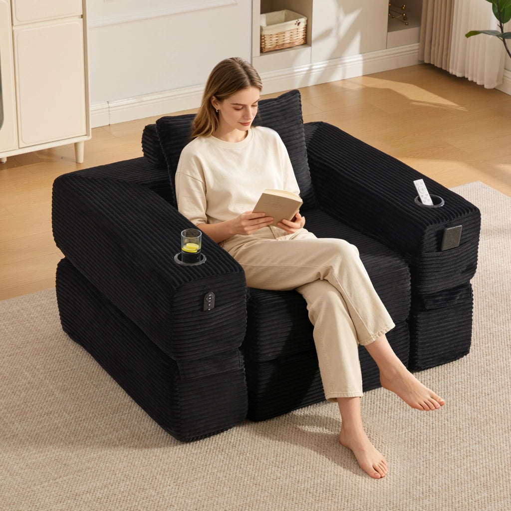 Divano convertibile in velluto a coste con molle, cuscini in memory foam, tasche laterali e portabicchieri nero