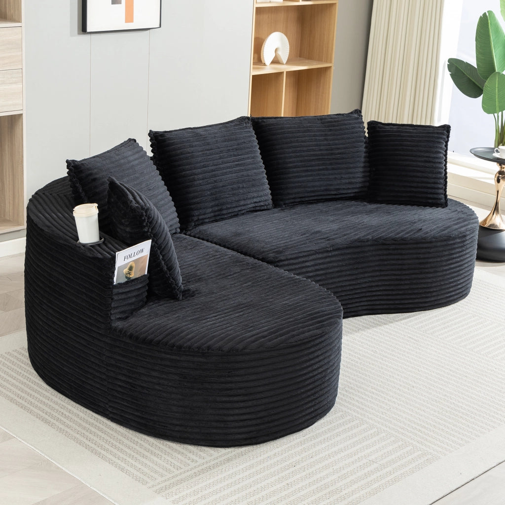 divano dritto dal design curvo con tasche laterali; portabicchieri e cuscino in velluto a coste nero
